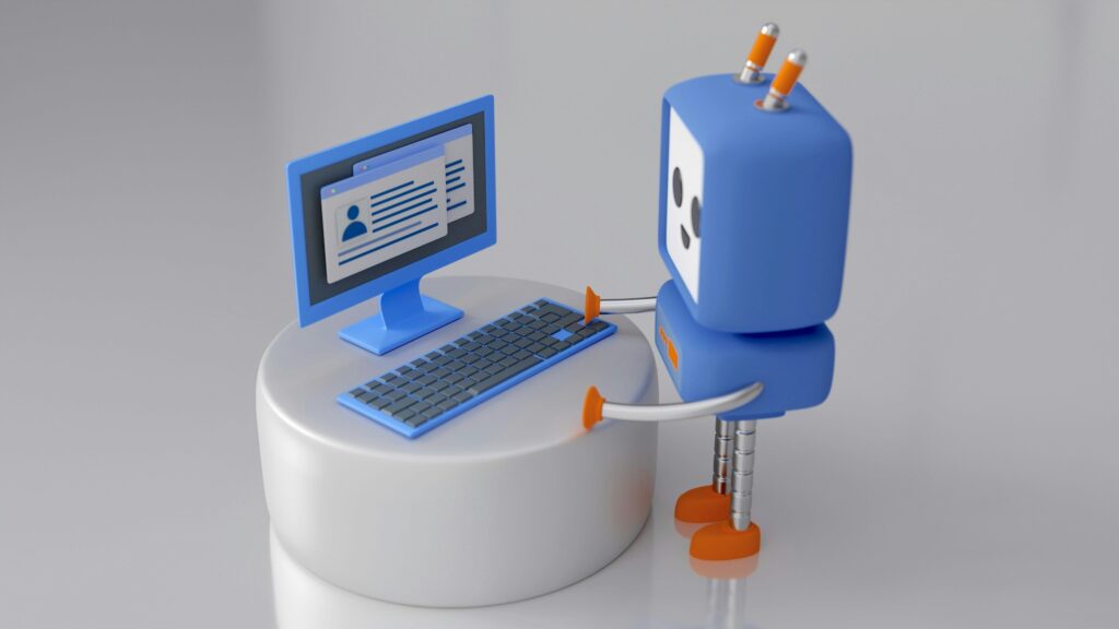A grey robot with a box head, pixel eyes and mouth on a white screen, red antennae, and red suctions for hands and feet, stands in front of a oval table, on which is a keyboard and monitor. The monitor shows a profile represented by a faceless profile pic and lines for text.